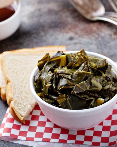 Cooked collard greens in a foam bowl, southern barbeque side